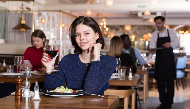 Woman Enjoying Dinner Alone In Restaurant