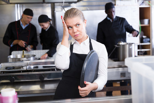 Disappointed waitress in restaurant kitchen