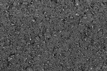 Texture of fresh hot asphalt. Black background resembling anthracite.
