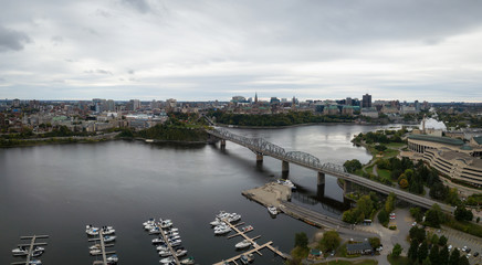 Fototapeta na wymiar Aerial panoramic view of Alexandra Bridge going over Ottawa River from Quebec to Ontario. Taken in Hull, Gatineau, Quebec, Canada.