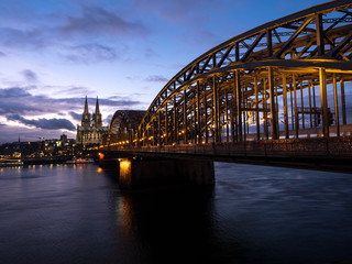 December 2018: Sunset sky with clouds over the city skyline Cologne with Bridge and Köln Dom ,Evening scene over Cologne/Koln city with Kolner Dom/Cathedral behind the Hohenzollern bridge