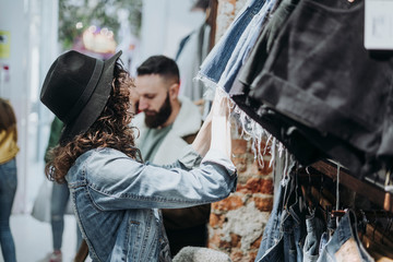 Woman buying clothes at the fashion store with boyfriend