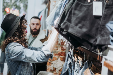 Woman buying clothes at the fashion store with boyfriend