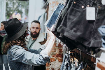 Woman buying clothes at the fashion store with boyfriend