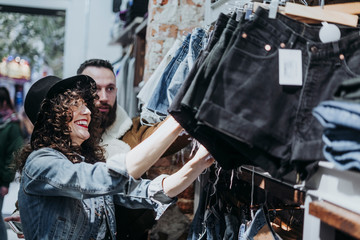 Woman buying clothes at the fashion store with boyfriend