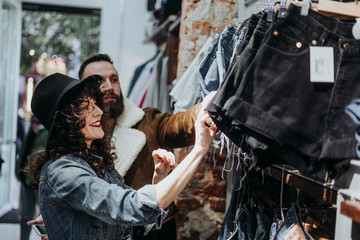 Woman buying clothes at the fashion store with boyfriend