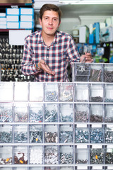 Employee in hardware store is trading goods for construction