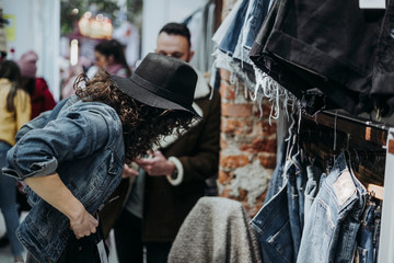 Woman buying clothes at the fashion store with boyfriend