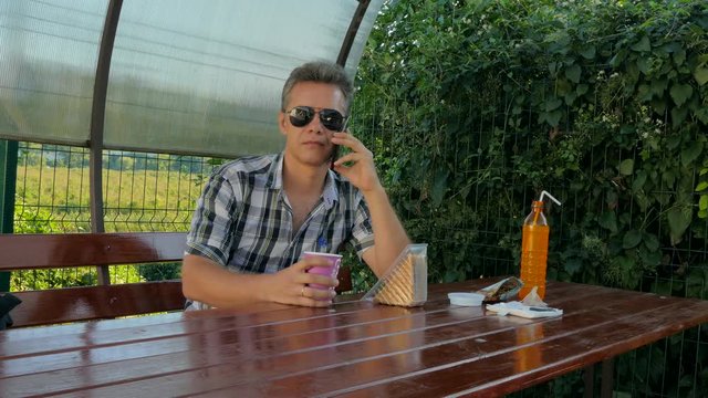 man in a cafe talking on the phone