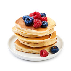Tasty homemade pancakes with berries on white background