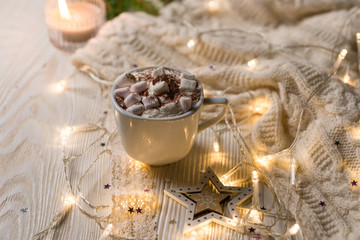 Obraz na płótnie Canvas Christmas coffee cup with marshmallows. Still life on white background. New Year's lights and decorations