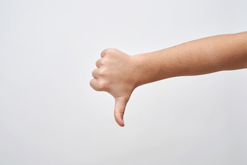 Child hand shows thump down.Negative sign of disagreement and unlike.
