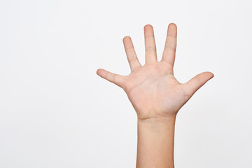 Child hand shows the number five.