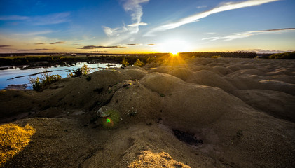 Sandy hills on the sunset. Lake in the Sandy canyon. Warm colors background. Yellow sandstone...
