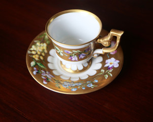 Romantic antique coffee cup with saucer in Biedermaier style, hand painted in gold and enamel with colorful flowers