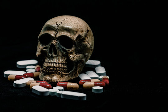 Skull and Pills on Black Background.