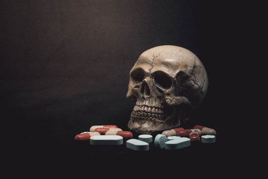 Skull and Pills on Black Background.