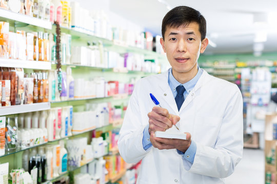 man pharmacist is inventorying medicaments