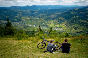 couple with bike on the mountains