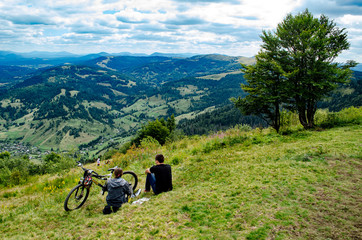 couple with bike on the mountains