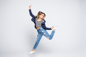 Full length portrait of cheerful woman jumping isolated on a white background