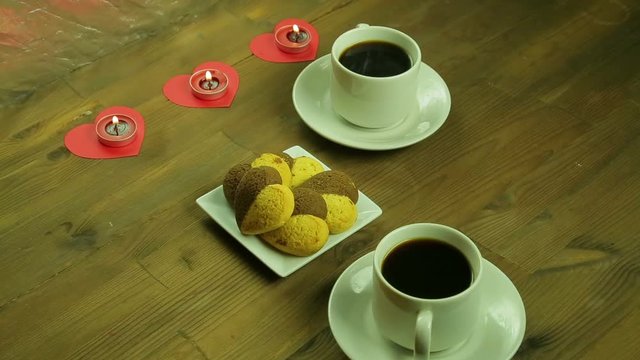 Young people in the cafe give each other gifts by candlelight.