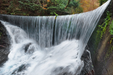 Fototapeta na wymiar Beautiful waterfall landscape in autumn scenary