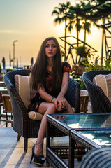 young woman in a beach cafe near swimming pool