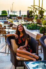young woman in a beach cafe near swimming pool