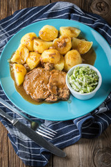Braised meat in sauce served with boiled potatoes.