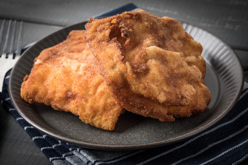 Two fried cod fillet pieces.