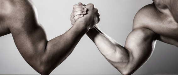 Two men arm wrestling. Rivalry, closeup of male arm wrestling. Two hands. Men measuring forces, arms. Hand wrestling, compete. Hands or arms of man. Muscular hand. Arm wrestling. Black and white. - obrazy, fototapety, plakaty