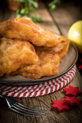 Fried cod slices in breadcrumbs.