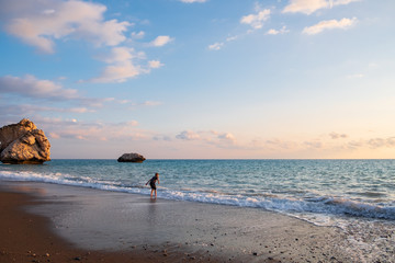 A barefooted boy plays at the beach at the Petra tou Romiou (Aphrodite's birthplace) rocks, in Paphos, Cyprus.