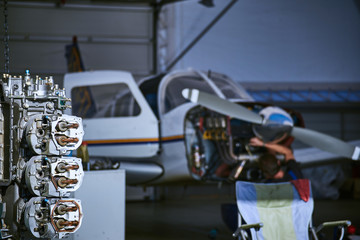 Removal and repair of an airplane engine by a service worker.