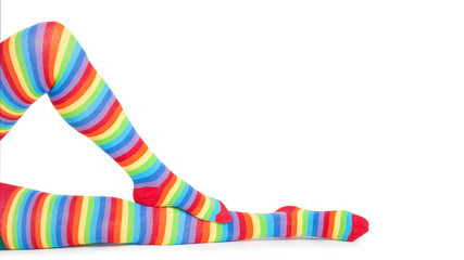 Perfect long female legs in rainbow stockings