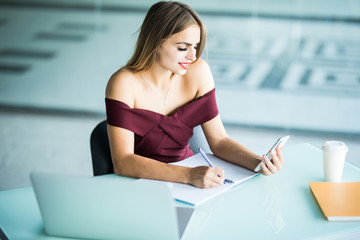 Beautiful young woman working sitting at her desk in the office