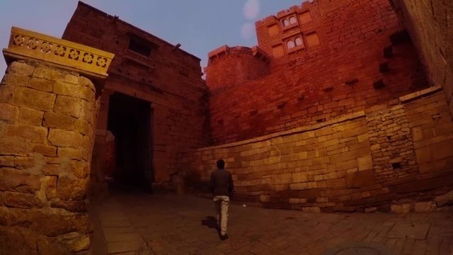Man walk about paving road inside Golden Fort Jaisalmer predown