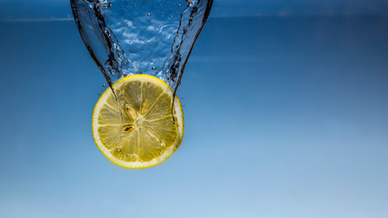 Lemon slices with water splash background close-up