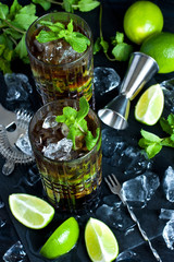 Cuba libre cocktail with rum, cola and lime, holidays party concept.