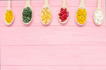 Supplements for sports omega in wooden spoons. Sport background. Healthy nutritional supplements....