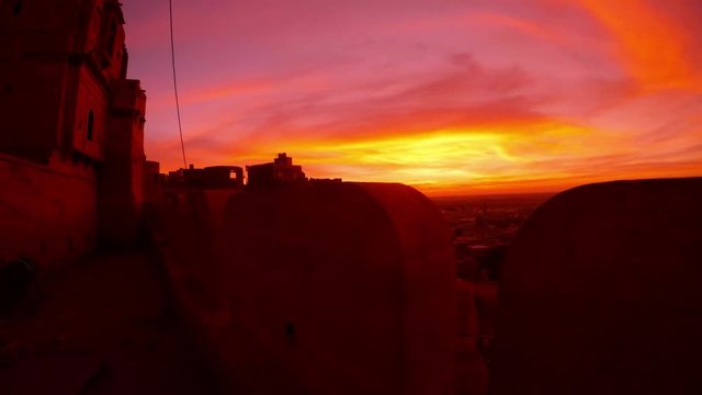Fantastic pink and perple predown sky over Golden Fort bird flies Jaisalmer