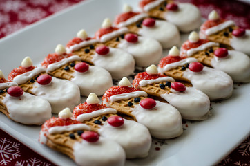 Santa shaped cookies on a white plate