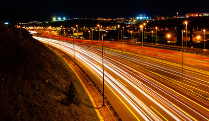Fototapeta na wymiar Waves of car lights at night on the highway