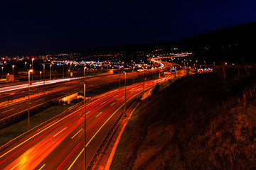 Fototapeta na wymiar Waves of car lights at night on the highway