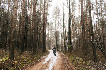 Portrait of happy young lovers of the bride and groom in the forest alley. Wedding day