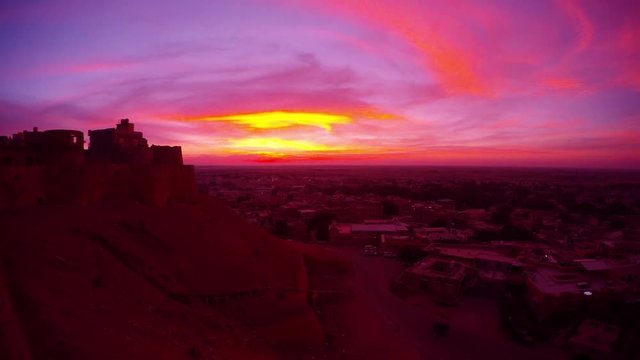 Phantasmagoric play of sky perple pink orange yellow violet colors over old fort Jaisalmer