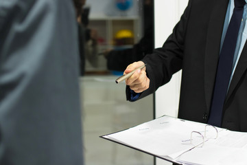 business people with documents and signing the contract