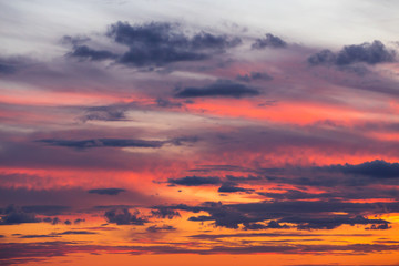 Beautiful dramatic sunset orange pink sky with clouds background