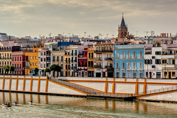 Fototapeta premium Colorful Triana neighborhood on the banks of Guadalquivir river in Seville, Spain.